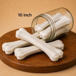 Ten-inch bone-shaped dog treats spilling from a glass jar onto a wooden surface.