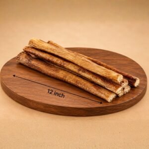 Several breadsticks stacked on a round wooden board with a 12 inch measurement line printed across the surface, showing their approximate length.