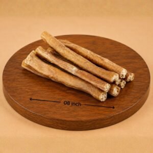Several light-brown breadsticks stacked on a circular wooden board marked '08 inch' for scale.